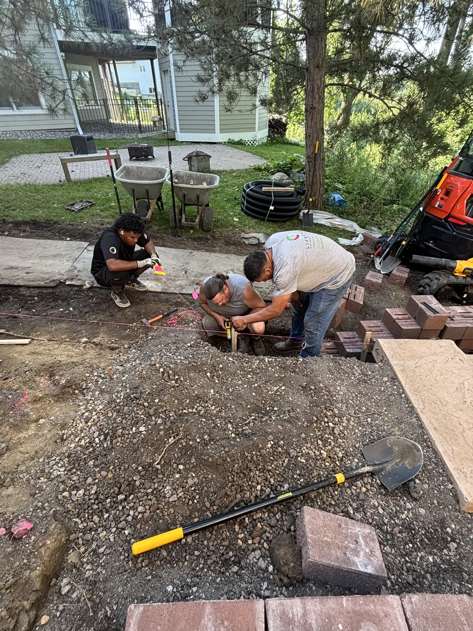 Close-up of engineered block retaining wall construction with proper drainage in Eden Prairie, MN