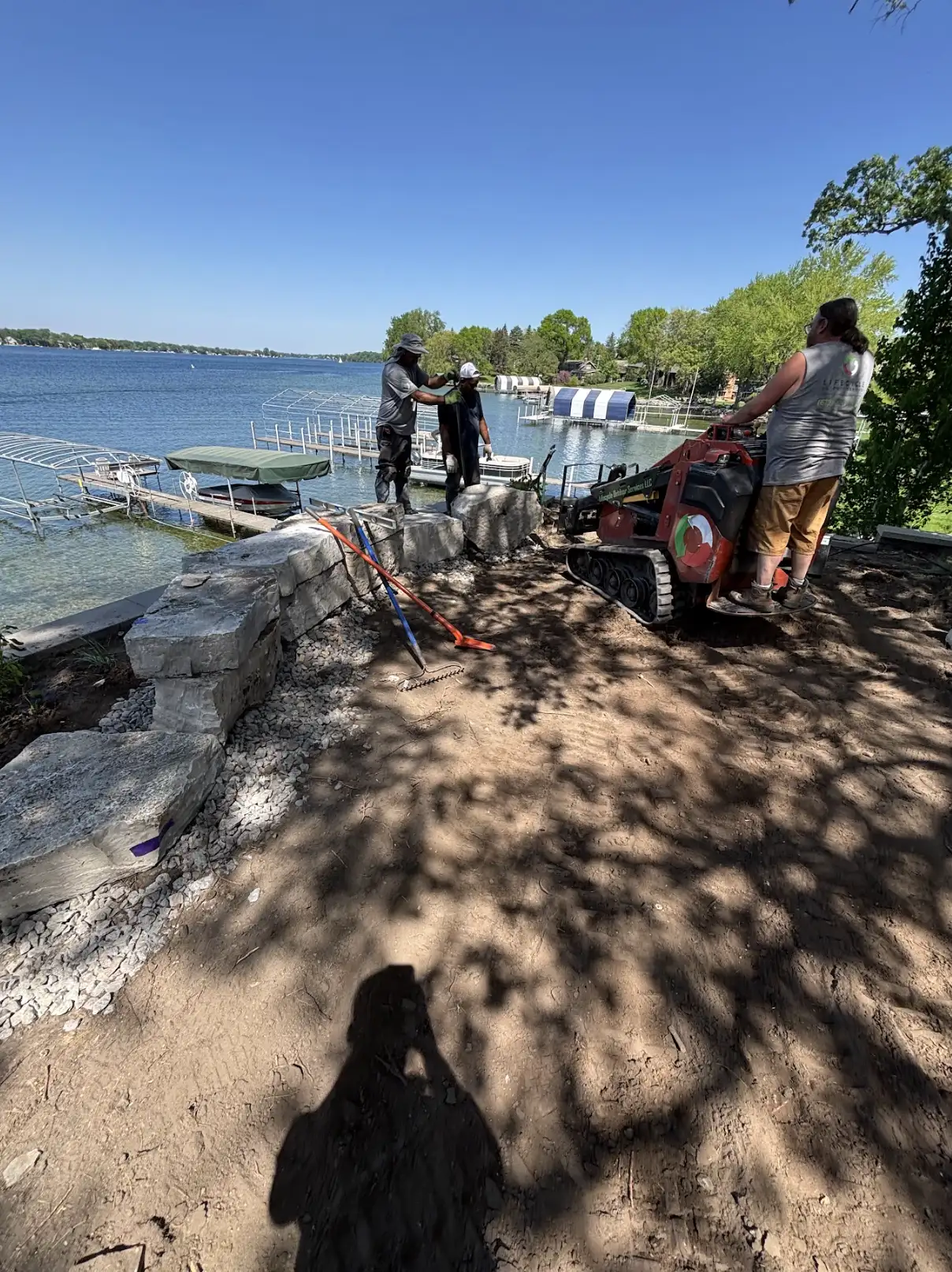 LED accent lights illuminating three-tier retaining wall system at night in Excelsior, MN