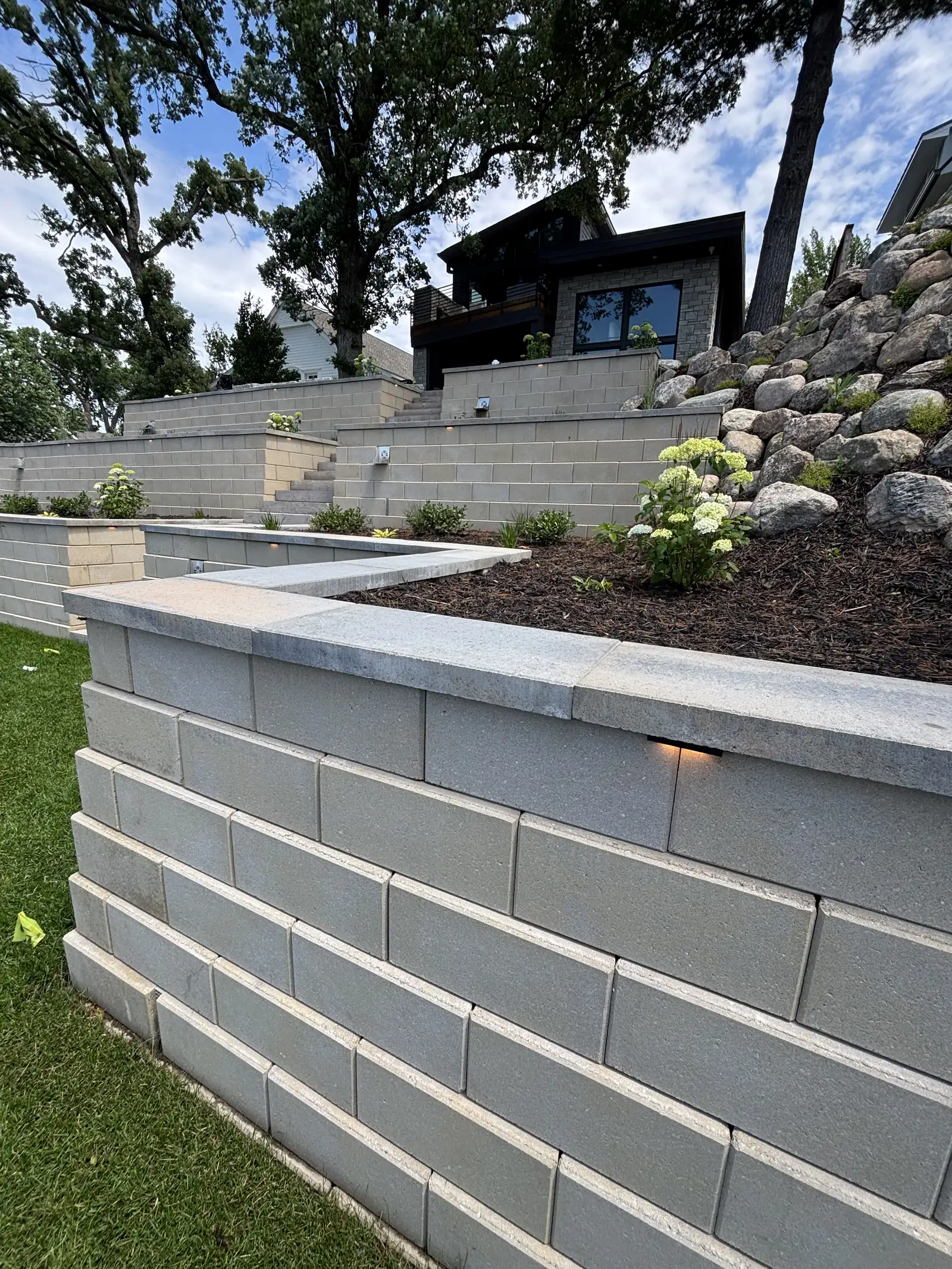 Completed multi-tier smooth-faced block retaining wall with LED lighting on Lake Minnetonka in Excelsior, MN