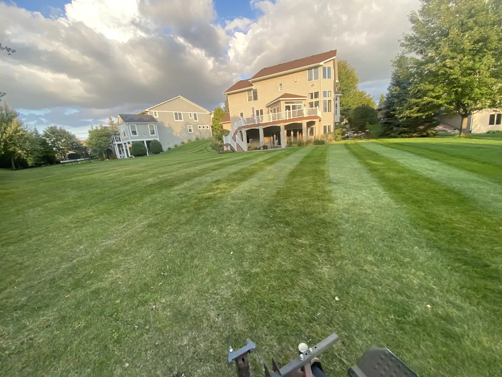 Large residential lawn with professional mow striping by Lifecycle Outdoor Services in the Lake Minnetonka area