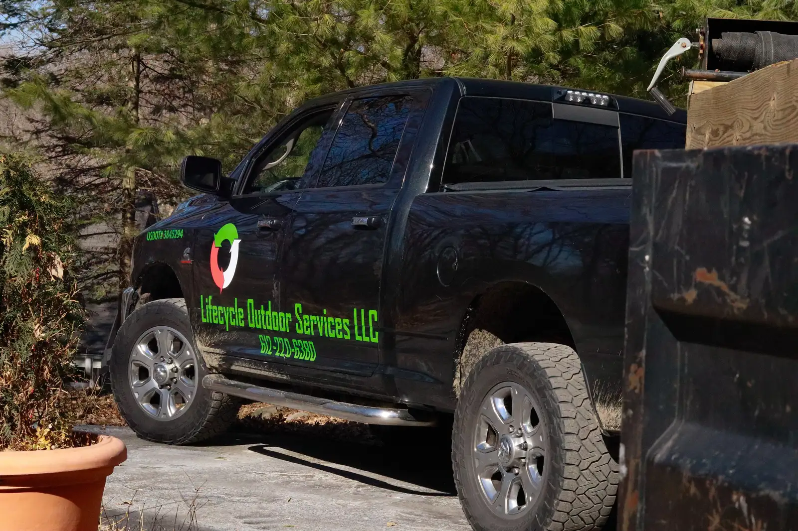Lifecycle Outdoor Services branded truck with company logo and phone number