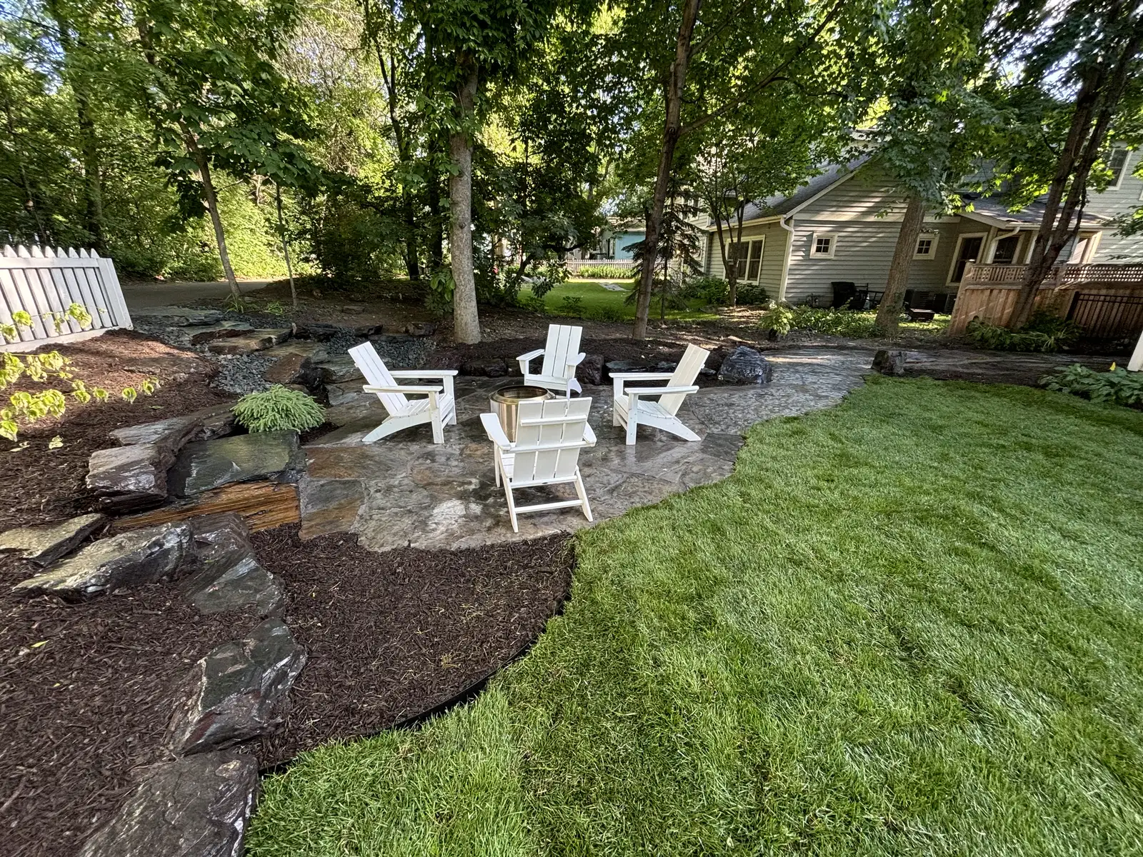Natural Superior boulder outcroppings with designed plantings in Greenwood, MN