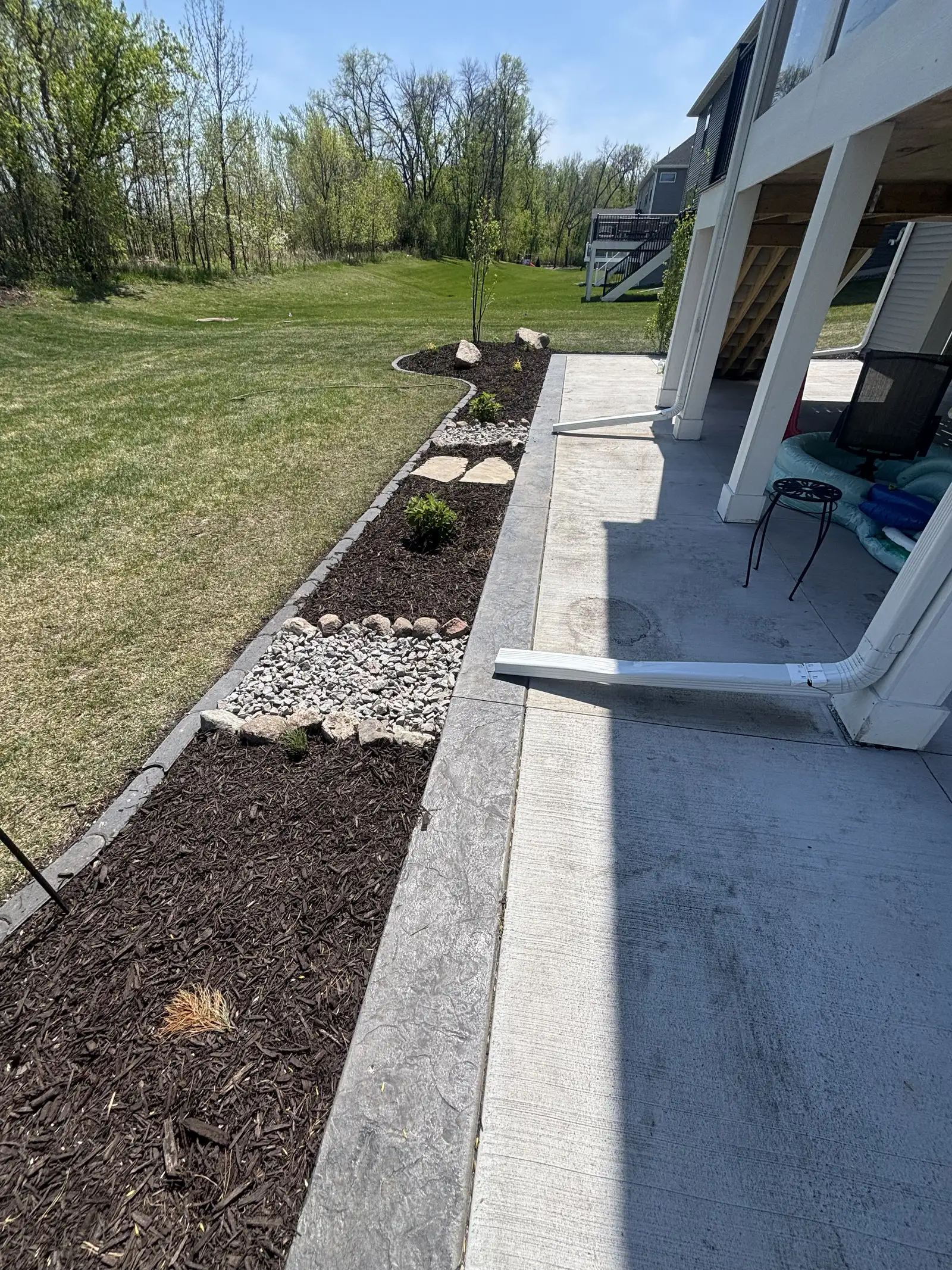 Detailed view of boulder outcroppings and granite rock landscape installation in Medina, MN