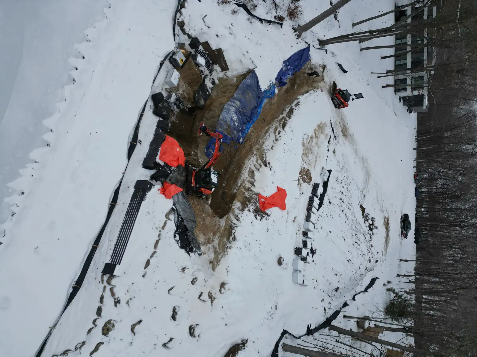 Engineered retaining wall and boulder system for hillside shoreline stabilization in Mound, MN