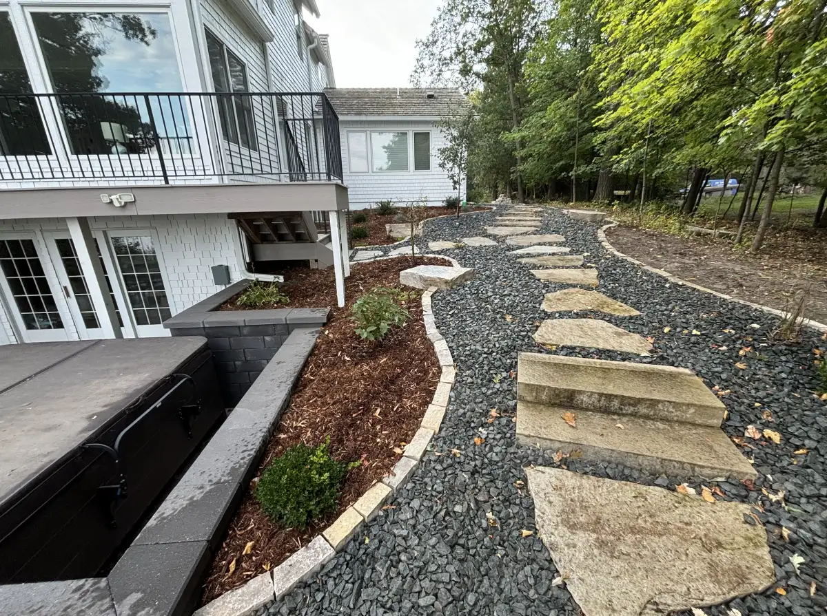 Completed landscape refresh with natural stone stepping path and trap rock in Orono, MN
